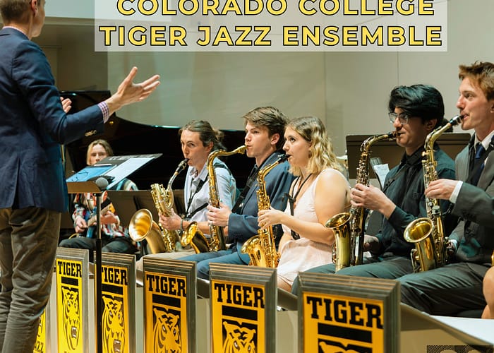 colorado college tiger jazz band practices while instructor raises his hands like a conductor and not like he's mad at his students